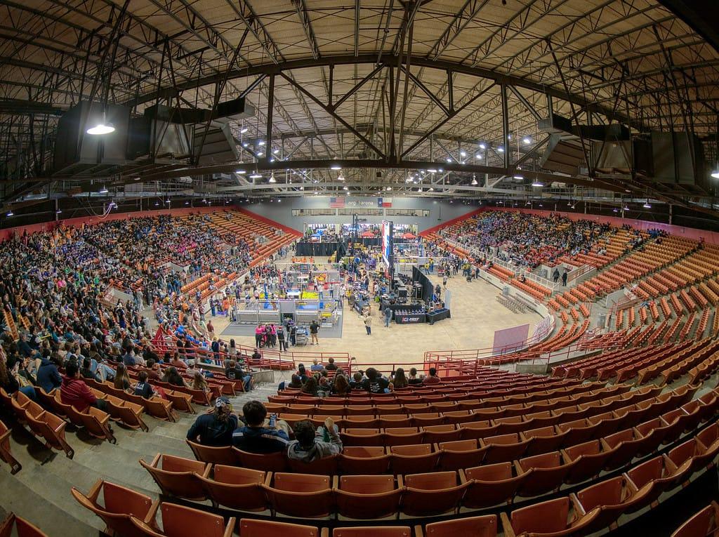 A packed arena around a FIRST Robotics Competition field at a Texas event
