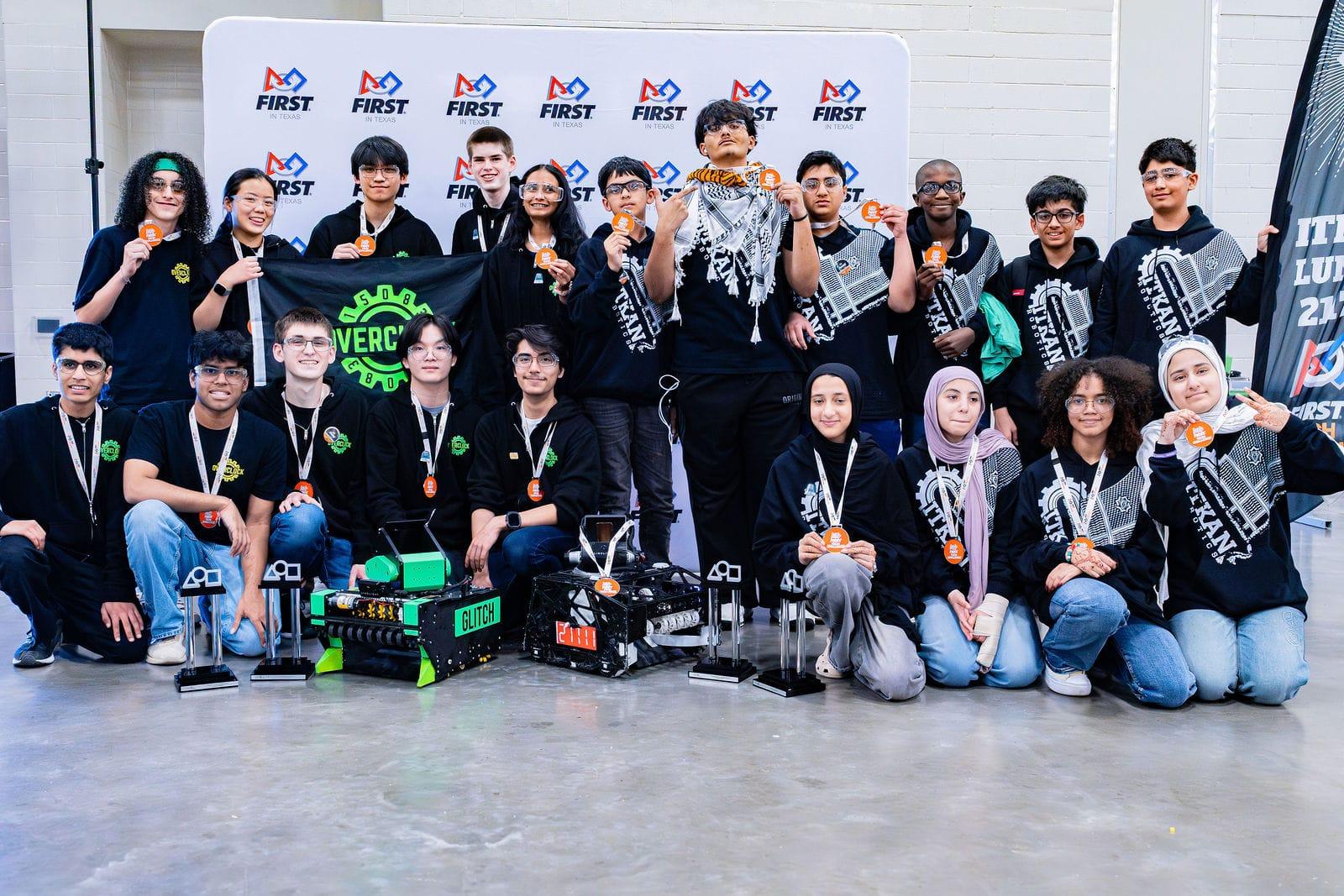 Two FIRST Tech Challenge teams with their medals and robots in front of the FIRST Texas backdrop